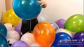 shy girl blow to pop big red balloon